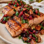 Cranberry Salmon with fresh cranberry salsa, toasted pecans, orange zest, herbs, and tender baked salmon