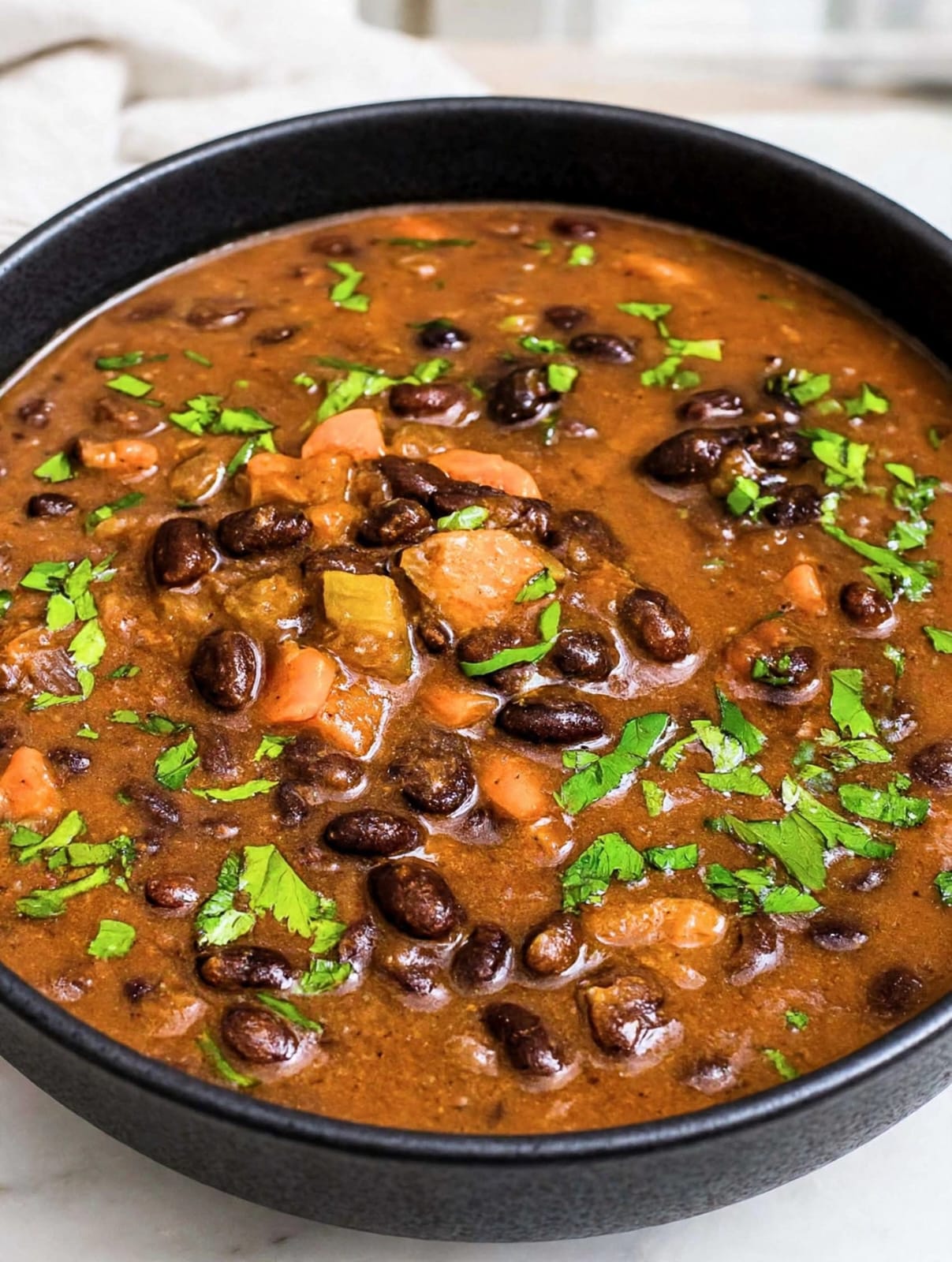 Black Bean Soup with black beans, tomatoes, carrots, celery, garlic, fresh herbs, and lemon