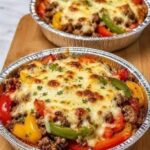 Crustless Pizza Bake with seasoned ground beef, pizza sauce, pepperoni, vegetables, mozzarella, and Parmesan