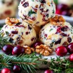 Christmas cranberry walnut cheese balls coated with dried cranberries, chopped walnuts, and fresh herbs