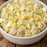 Creamy American potato salad with tender potatoes, hard-boiled eggs, celery, and mustard dressing
