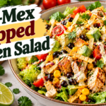 Tex-Mex Chicken Salad with seasoned chicken, black beans, corn, avocado, tomatoes, cheese, and creamy lime dressing